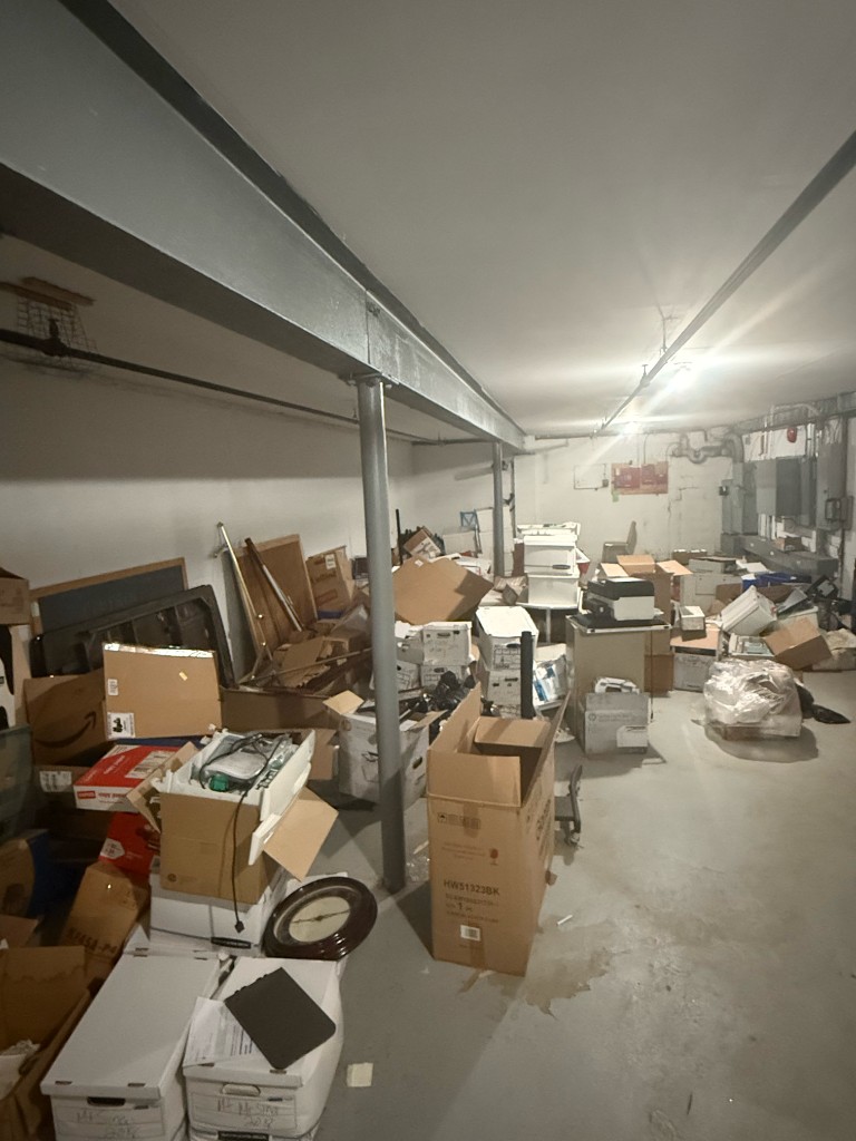 Cluttered basement before junk removal